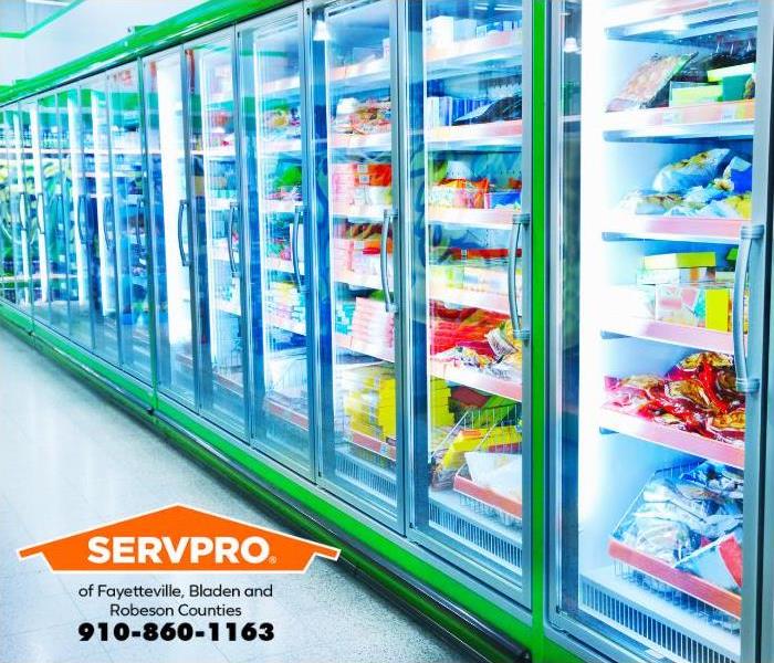 Commercial refrigerators are seen in a grocery store.